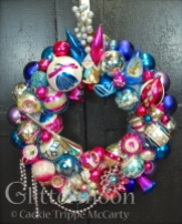 For you deep pink and blue lovers here is a gorgeous wreath packed with so much terrific stuff. Notice the sly look that adorable (but mischievous) elf is casting at the Christmas Princess on the jumbo Poland ball next door. $285 ** SOLD **