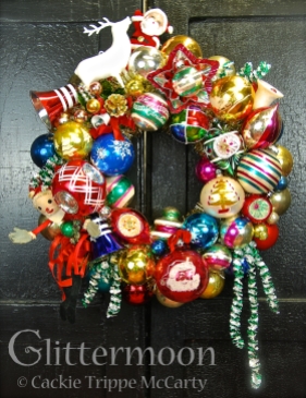 A very Merry Christmas to all with this joyful, multi-colored wreath. Featuring a wonderful bendy Santa (he still had his original price tag from Blum's department store) on the left, a white reindeer on top next to a jolly little Santa, and tons of fabulous vintage ornaments. Trimmed out with old foil garland for extra spice. Approx. 17" diameter. $195 ** SOLD **
