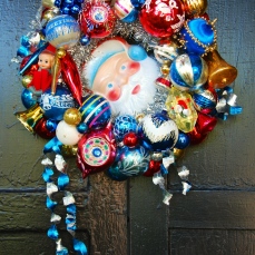 SANTA BLUE A petite wreath (approx. 14" diameter) in festive colors. Featuring a darling Santa face in the center. $125 ** SOLD **