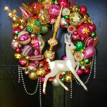 HOT FLASH. Hot, poppy colors abound on this wreath, featuring a rare, huge (13" tall) celluloid deer and a gold topper as the focal points. 20" diameter $295 SOLD