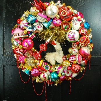 The Lama Wreath, made especially to hang in the Beekamn 1802 Mercantile, Sharon Springs, NY. The largest wreath I have made to date and just loaded with all kinds of fab goodies; with a miniature Polka Spot (the llama) dress in her holiday finery of rhinestones and a Santa hat. About 27" diamater $525 *SOLD*