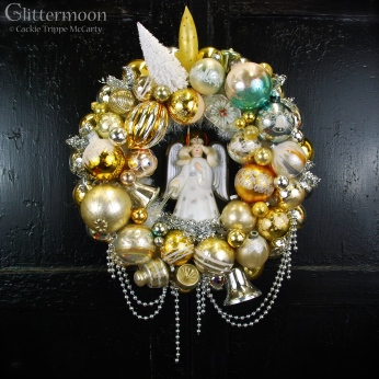 Angel Glow Wreath. Lovely soft golds, silvers, and whites surround a working vintage Noma angel tree topper. She emits a pretty soft glow when plugged in! $265 with storage bag